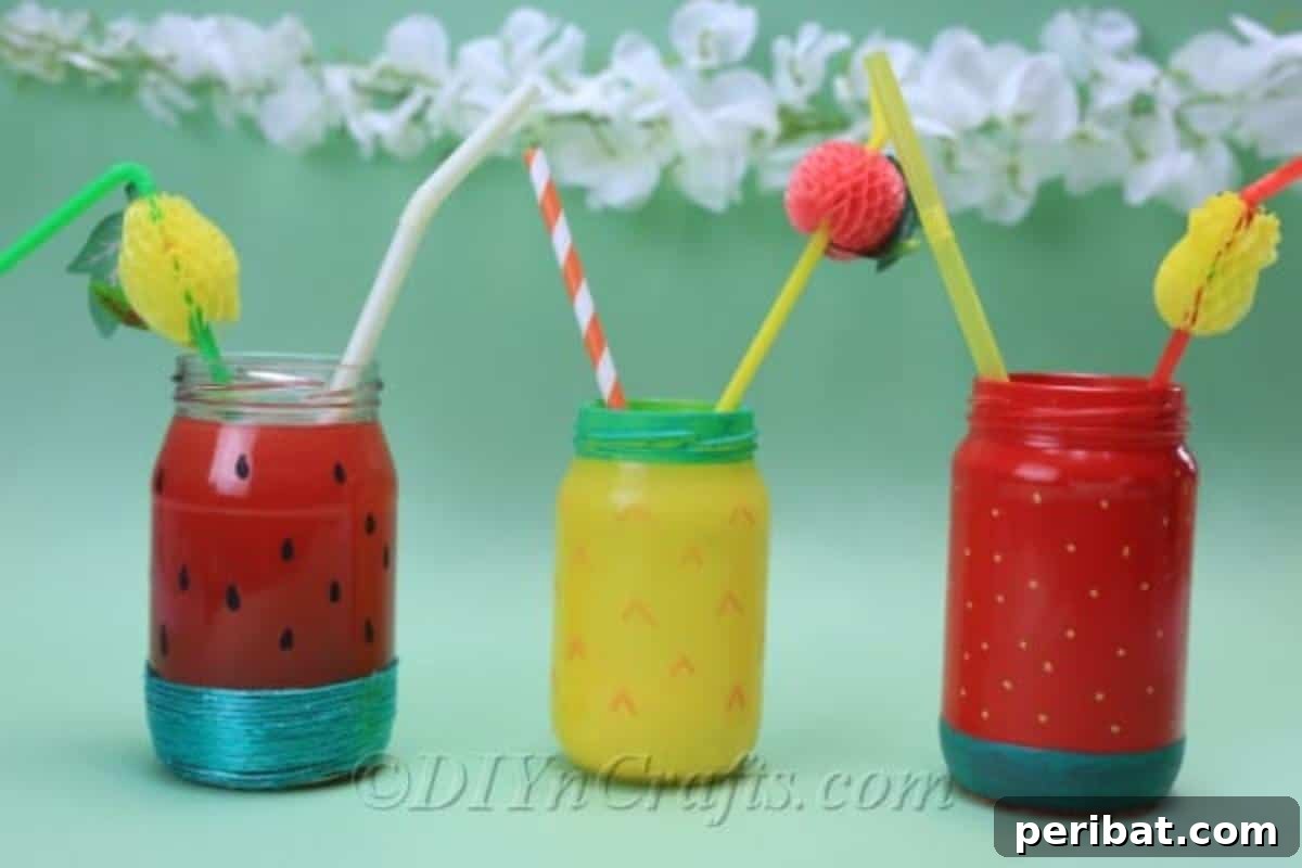 Vibrant Painted Jars for Summer Drinks 3 Refreshing beverages are stylishly served in these charming summer fruit drink jars, perfect for a sunny day.
