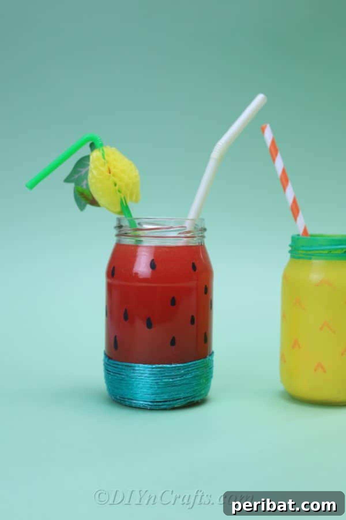 Vibrant Painted Jars for Summer Drinks 5 Three beautifully fruit-painted jars, adorned with straws, stand against a minimalist plain backdrop, ready for use.