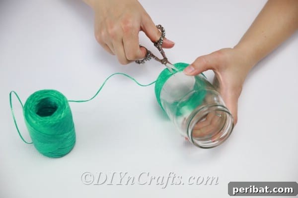 Once the green section is complete, carefully cut the string and glue down the final end securely.