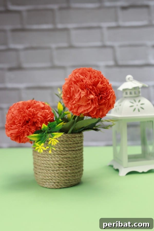 A vibrant finished tissue paper pom-pom flower ready for display, showcasing its intricate layers and full shape.