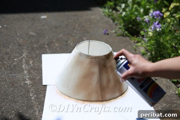Apply an even coat of spray paint to your lampshade, choosing a color that complements your desired outdoor aesthetic.