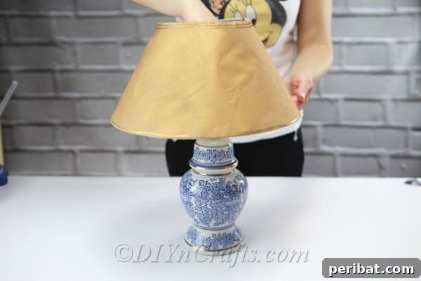 After the paint has fully dried, carefully reattach the lampshade to the lamp base.
