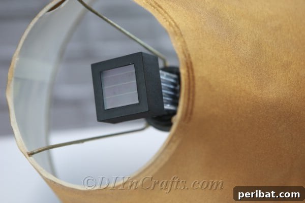 Securely attach the solar light unit within the lamp's former bulb socket using hot glue.