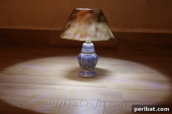 The newly created solar lamp rests on the ground, shedding a soft, inviting glow as evening approaches.