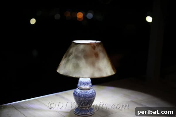 The upcycled solar lamp illuminates a dark outdoor space, showcasing its effectiveness and charm.