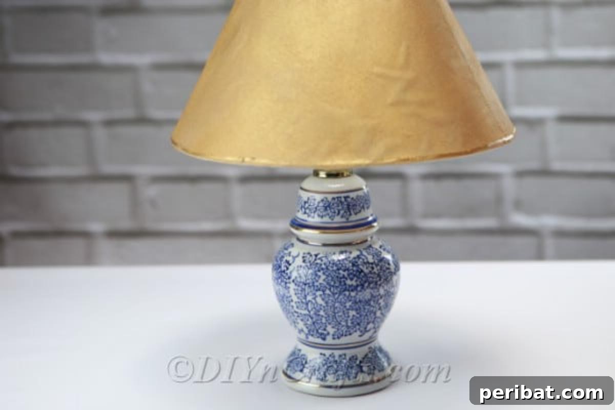 A charming DIY solar garden lamp, created from a repurposed table lamp, sits elegantly on a patio table, ready to illuminate the evening.