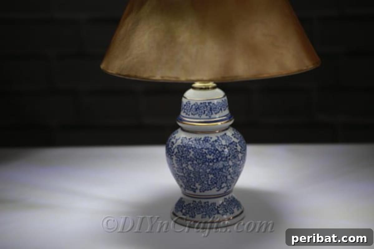 A meticulously crafted solar garden lamp casts a soft, warm glow on a garden table, highlighting its upcycled design.
