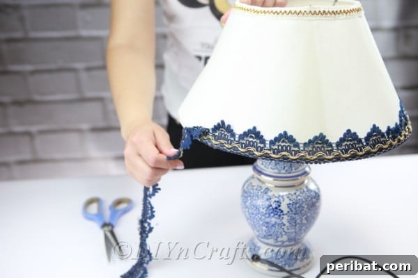 Continue to remove all unnecessary embellishments from the lampshade, ensuring a clean surface for your DIY project.
