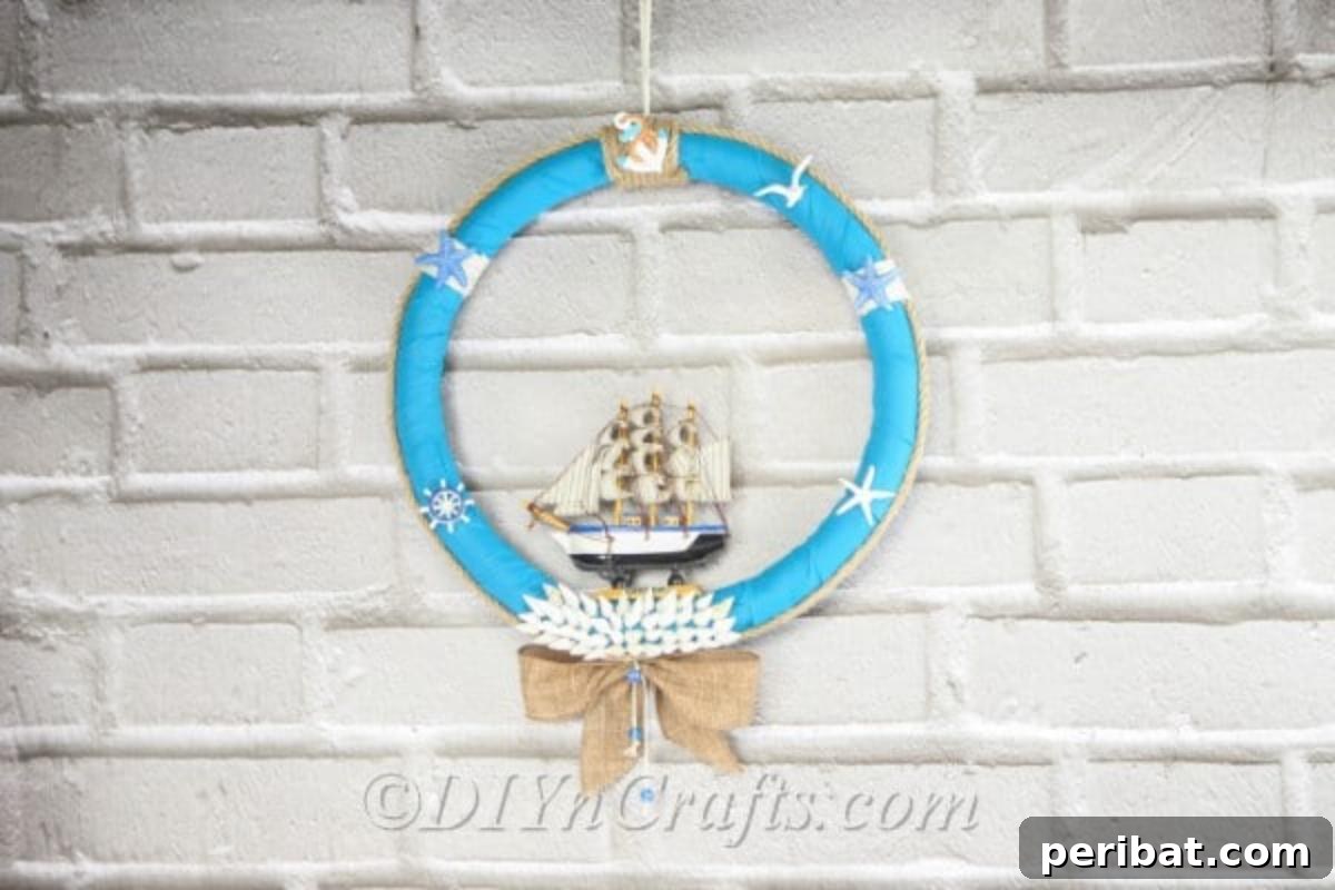 Coastal Elegance: Craft Your Perfect Summer Wreath 2 A beautifully crafted DIY nautical wreath, featuring rope, shells, and a miniature boat, hangs gracefully against a wall, ready to welcome summer guests.