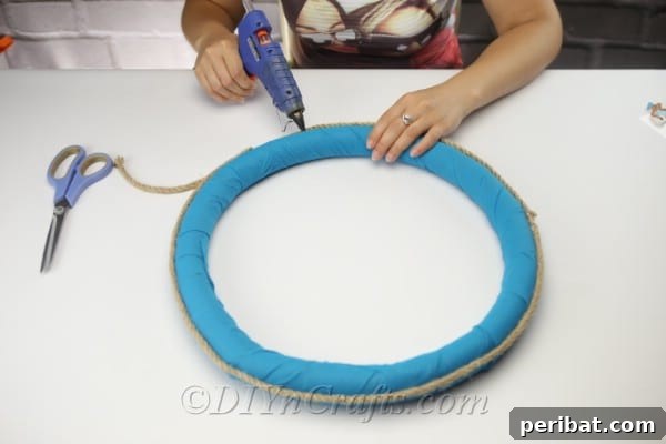 Coastal Elegance: Craft Your Perfect Summer Wreath 14 Continue to apply hot glue and wrap the rope evenly around the entire wreath perimeter.