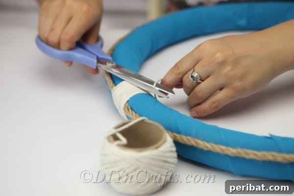 Coastal Elegance: Craft Your Perfect Summer Wreath 17 Once finished wrapping the string, cut it neatly and secure the end with a final dot of hot glue.