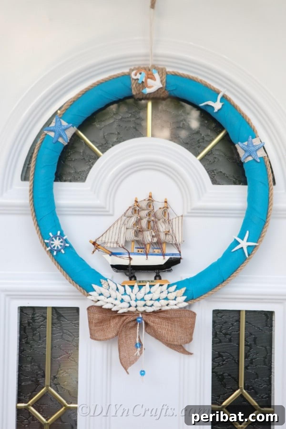 Coastal Elegance: Craft Your Perfect Summer Wreath 3 A stunning handmade nautical wreath, adorned with a miniature boat, seashells, and rope accents, hanging on a rustic wooden door, welcoming guests with its coastal charm.
