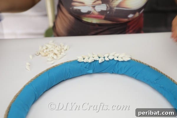 Coastal Elegance: Craft Your Perfect Summer Wreath 20 Complete your beautiful seashell pattern at the bottom of the nautical wreath.