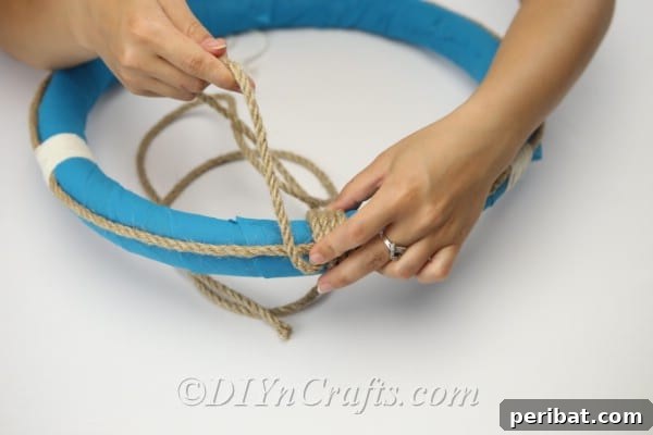 Coastal Elegance: Craft Your Perfect Summer Wreath 21 Wrap additional rope around the top of the wreath, reinforcing the hanging loop.