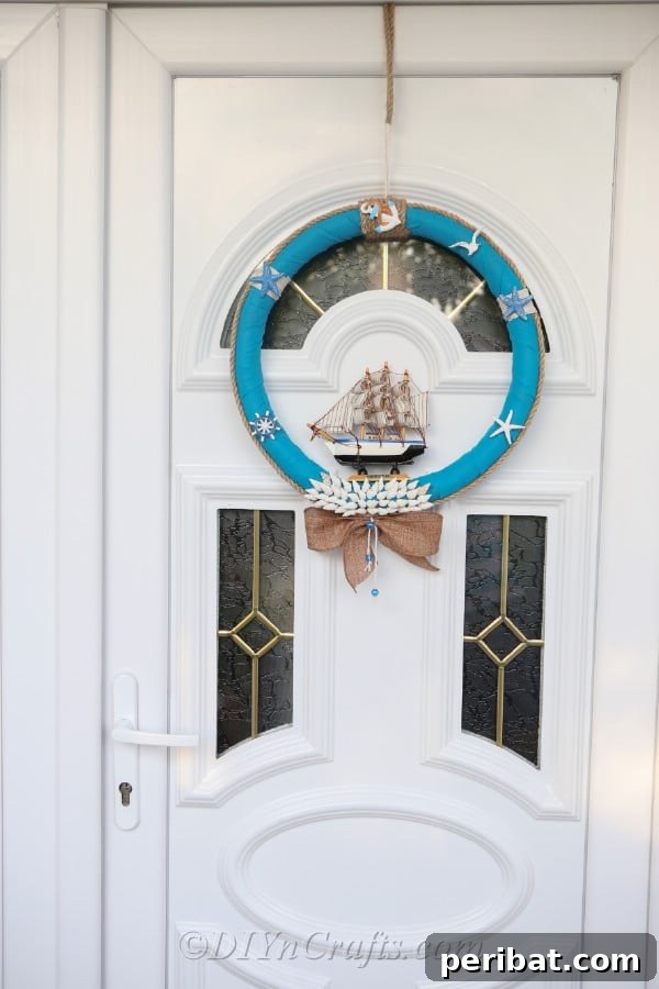 Coastal Elegance: Craft Your Perfect Summer Wreath 29 A beautifully completed DIY nautical wreath hanging gracefully on a pristine white door.