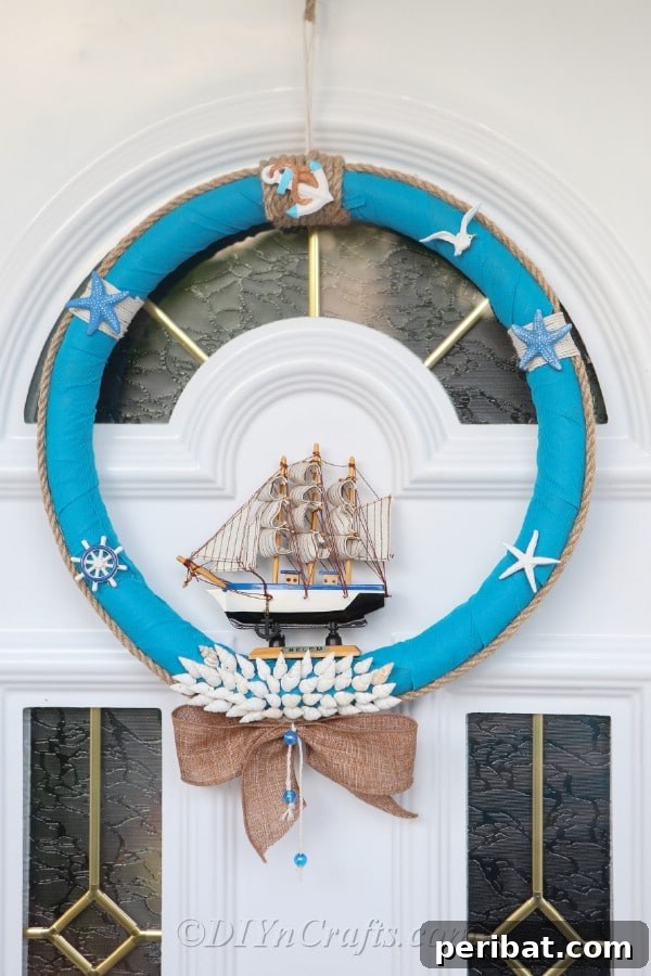 Coastal Elegance: Craft Your Perfect Summer Wreath 30 A closer view of the elegant nautical wreath, highlighting its intricate details, as it hangs on a door.
