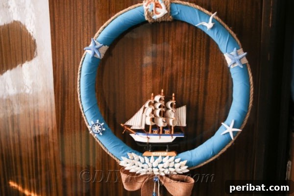 Coastal Elegance: Craft Your Perfect Summer Wreath 31 A charming nautical wreath with blue and white tones, accented by shells and rope, displayed against a rustic wooden background.