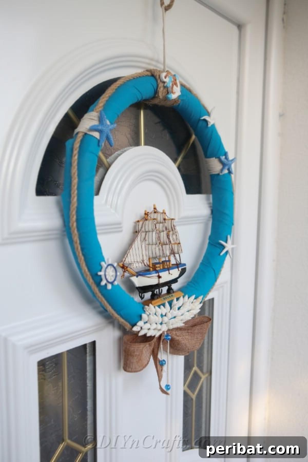 Coastal Elegance: Craft Your Perfect Summer Wreath 33 A side profile view of the completed DIY nautical wreath, showcasing its depth and various layers of oceanic elements.