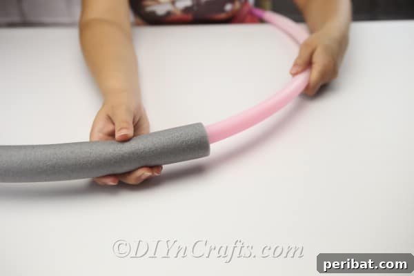 Coastal Elegance: Craft Your Perfect Summer Wreath 8 Carefully stuff the hula-hoop or wire inside the foam tube.