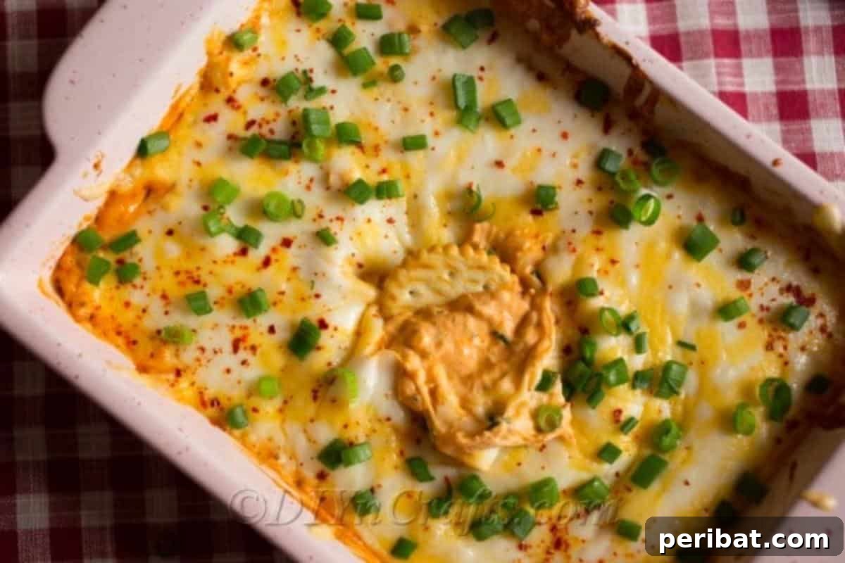 Quick & Creamy Buffalo Chicken Dip 3 Large casserole dish filled to the brim with bubbly, golden-brown buffalo chicken dip, ready to serve