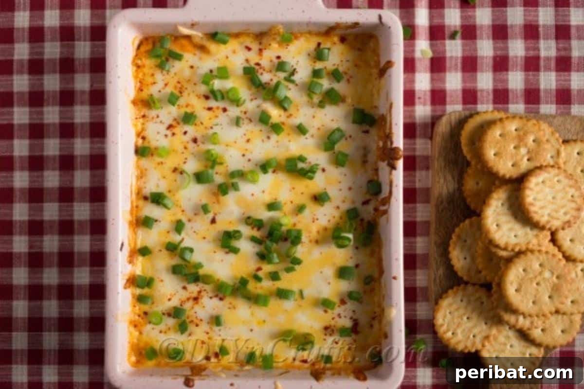 Quick & Creamy Buffalo Chicken Dip 5 Delicious buffalo chicken dip prepared in a casserole dish, garnished with vibrant sliced green onions