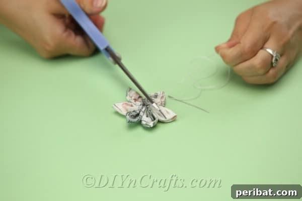 After securing the petals with a knot, carefully cut away any excess thread for a clean finish.