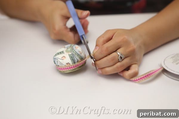 Clever Pincushion Jar Sewing Caddy 14 After encircling the lid with ribbon, carefully trim any excess to ensure a seamless and professional-looking finish.