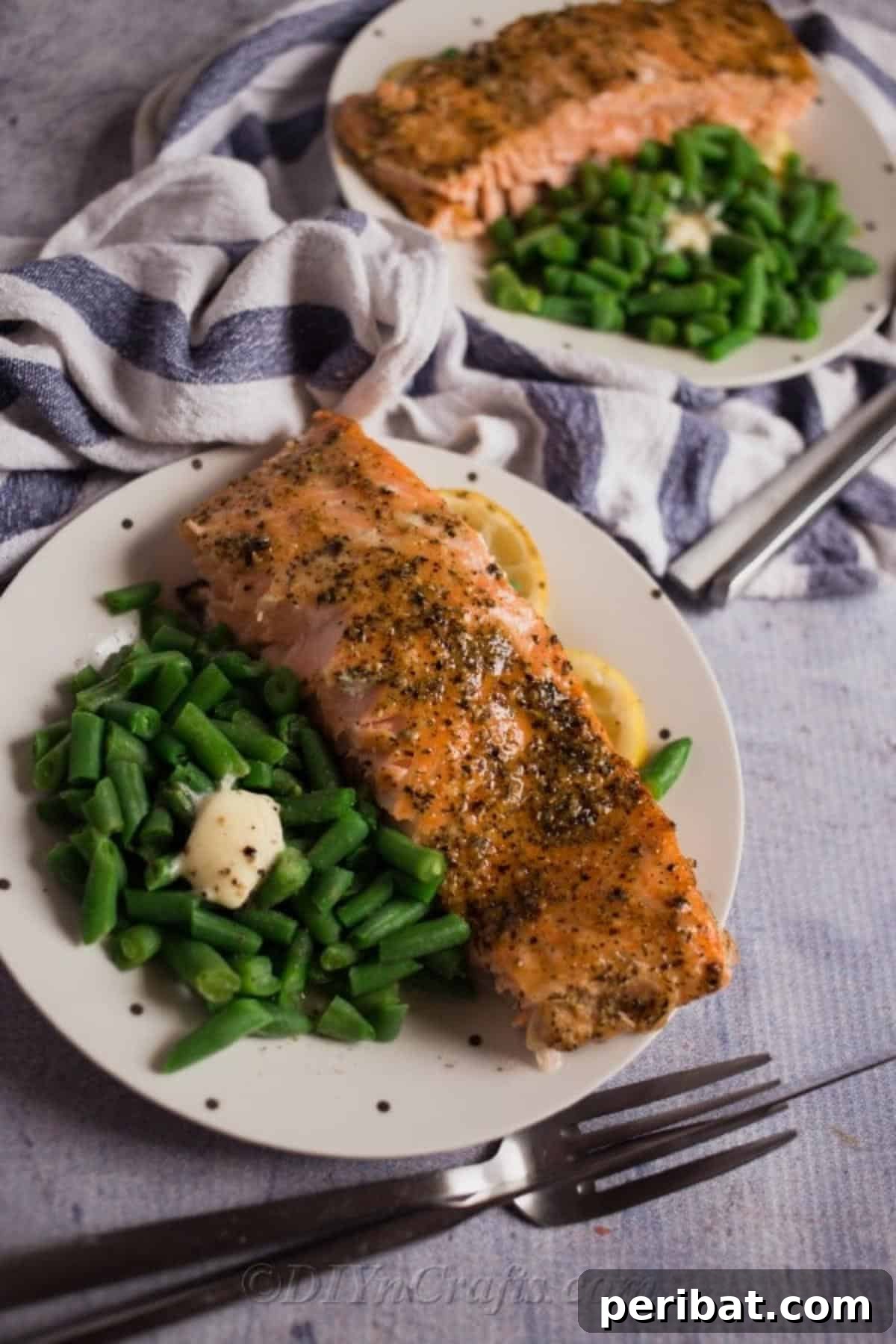 Perfectly Glazed Honey Garlic Salmon 4 A place setting with two plates of baked salmon and green beans