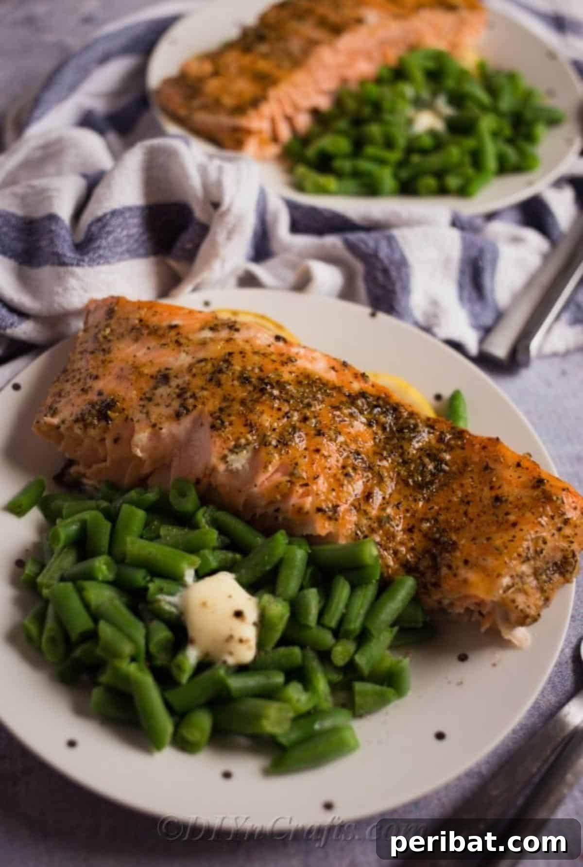 Perfectly Glazed Honey Garlic Salmon 6 Up close picture of baked salmon with honey and garlic sauce on white plate