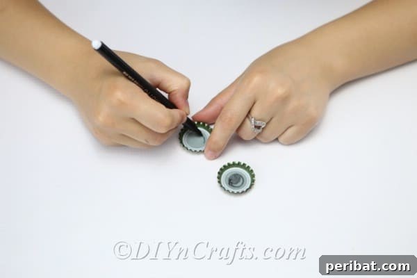 DIY Whimsical Hanging Garden Bees 15 A woman drawing eyes inside bottle caps for the hanging bee craft