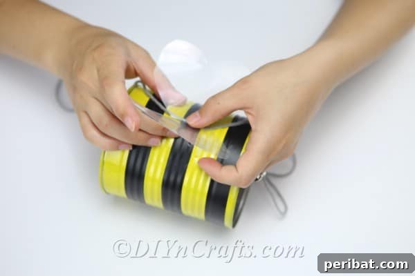 DIY Whimsical Hanging Garden Bees 20 Attaching wings and hanging thread onto the tin can bee craft