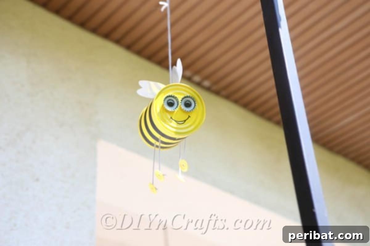 DIY Whimsical Hanging Garden Bees 5 Tin can bee craft hanging from a porch