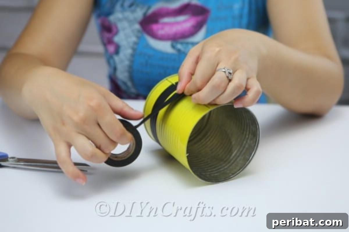 DIY Whimsical Hanging Garden Bees 8 A picture showing a woman threading twine through holes to create legs on bee craft