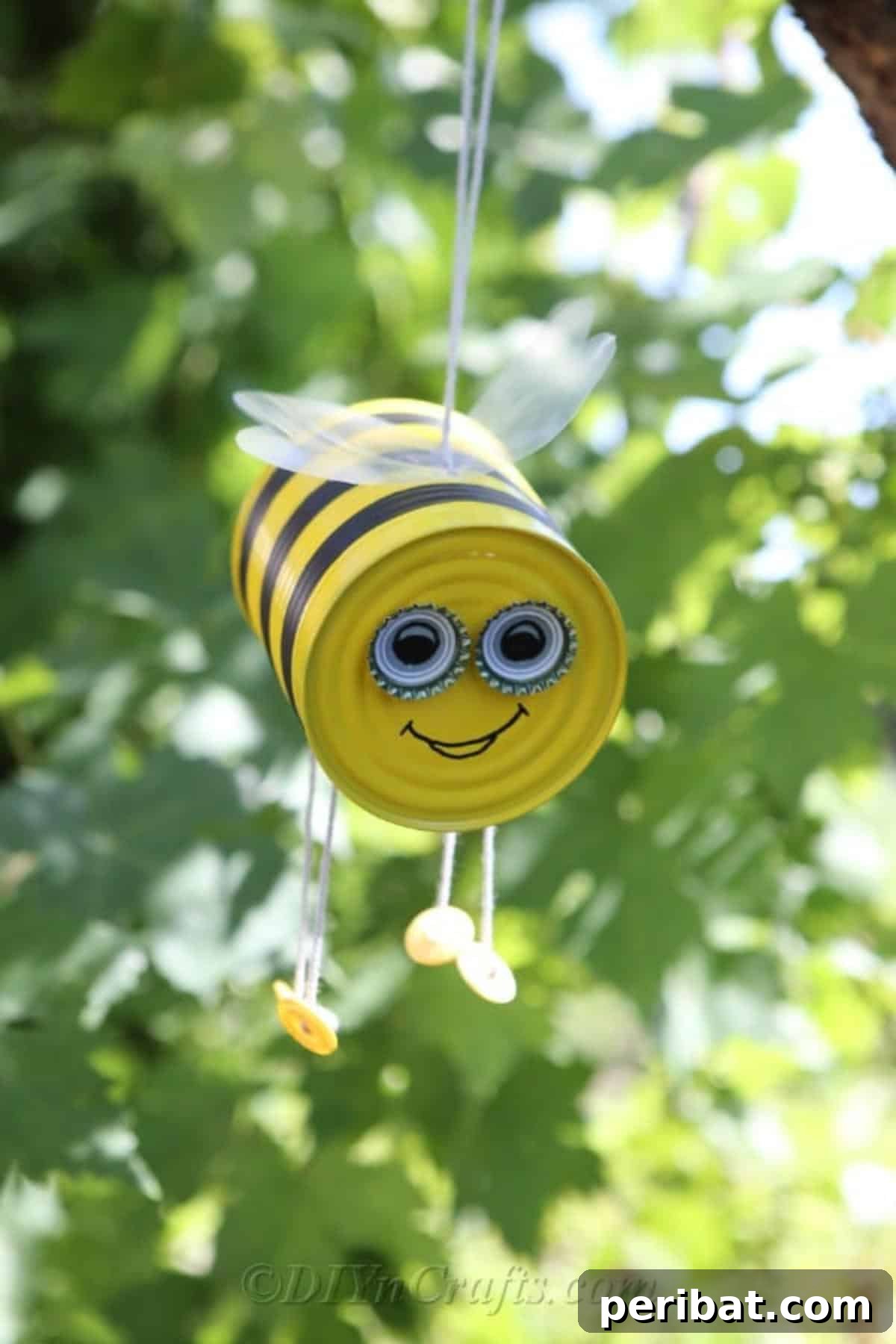 DIY Whimsical Hanging Garden Bees 10 Tin can bee craft hanging from a tree