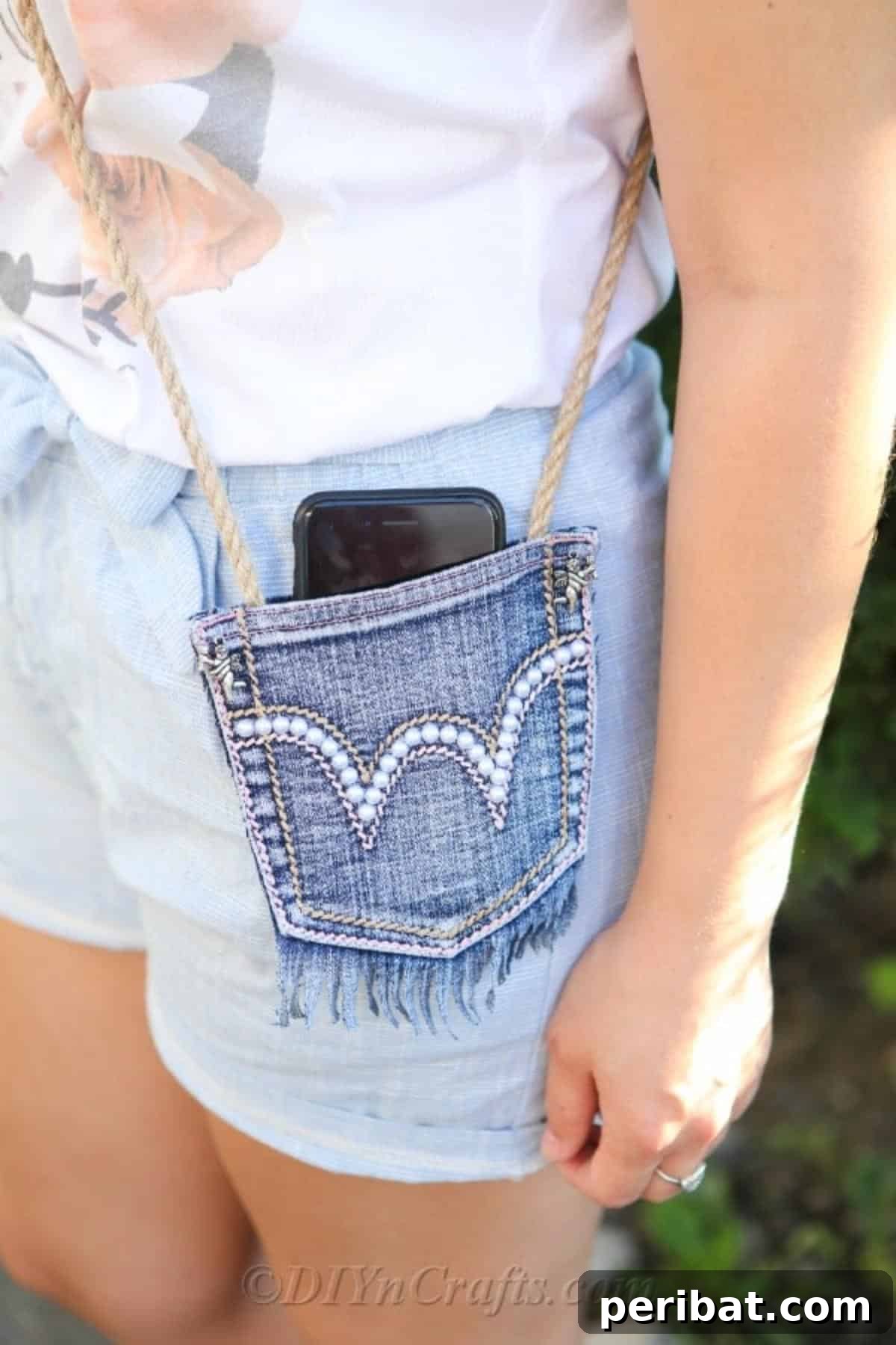 Craft Your Own Chic Denim Bag 13 Woman standing outside, radiating confidence as she carries her newly created homemade denim bag over her shoulder.