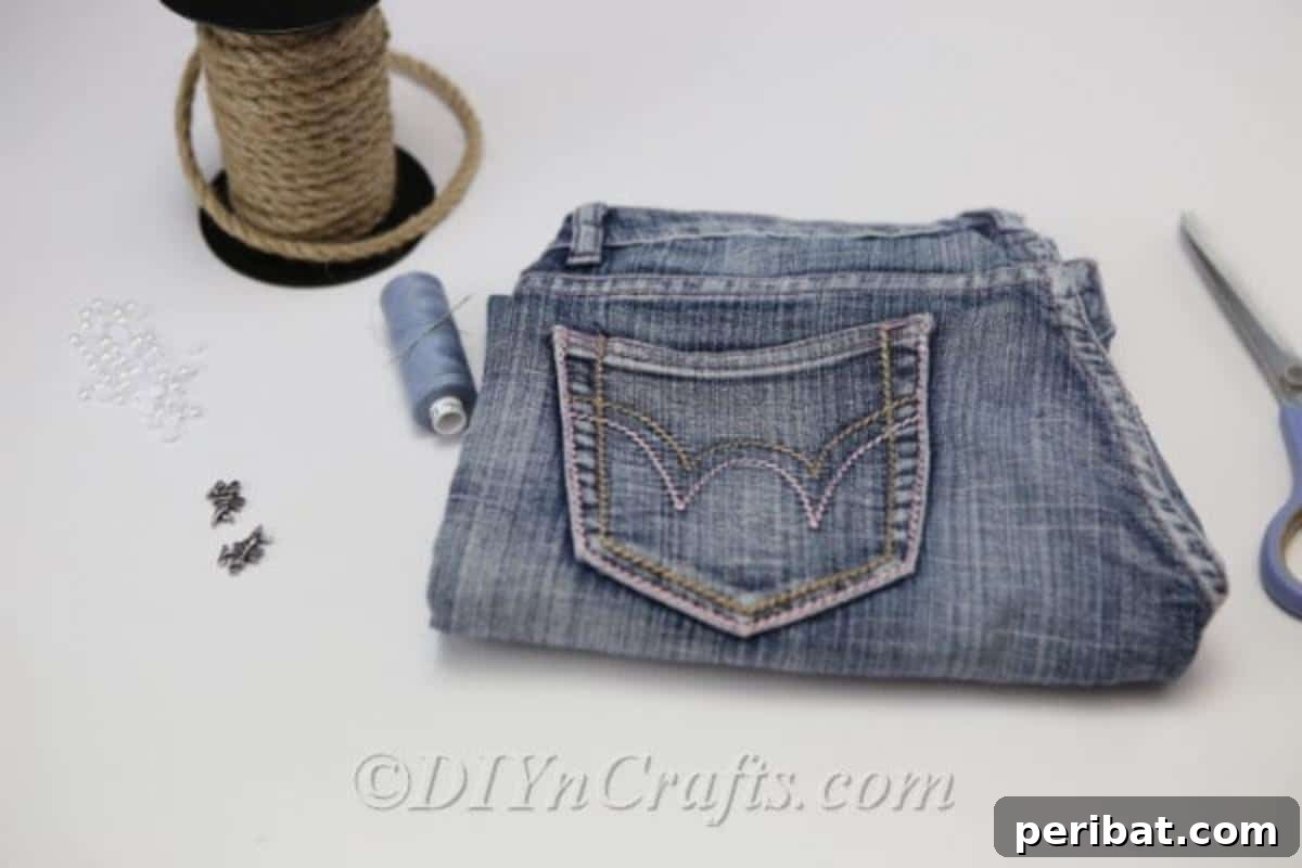 Craft Your Own Chic Denim Bag 7 A flat lay of all the simple supplies needed to create a homemade denim bag: old jeans, rope, embellishments, scissors, and a glue gun.