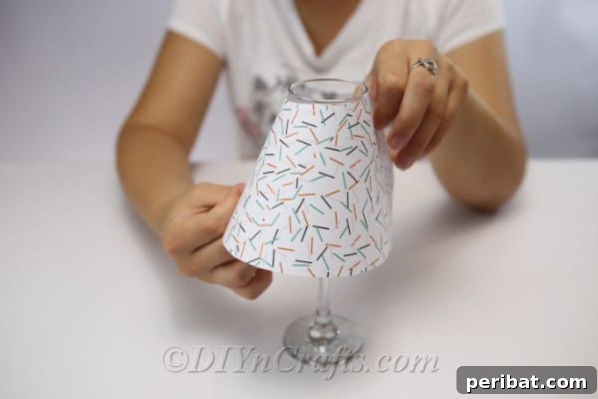 Upcycled Wine Glass Tealight Lanterns 10 Woman attaching paper shade to diy wine glass lantern