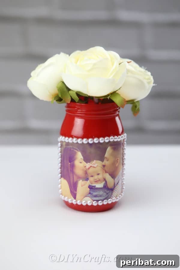 Create Stunning Photo Vases with Your Memories 14 Flowers in a DIY jar vase displaying a photograph.