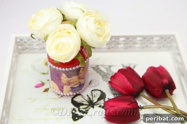 Create Stunning Photo Vases with Your Memories 15 A DIY vase with flowers in it and some more flowers nearby.