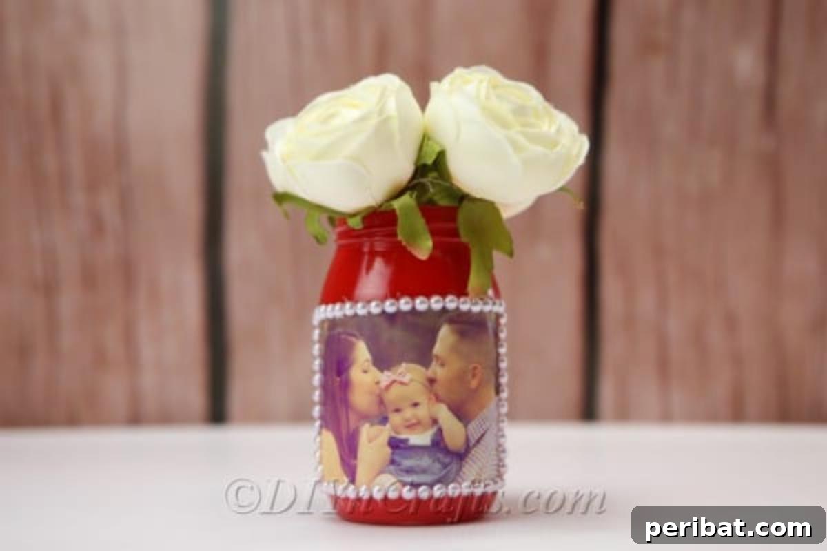 Create Stunning Photo Vases with Your Memories 3 DIY vase featuring a family photo displayed with wooden wall in the background.