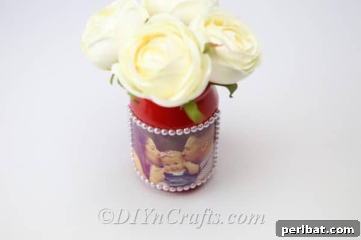 Create Stunning Photo Vases with Your Memories 17 A DIY vase with flowers in it seen from a slight overhead angle.