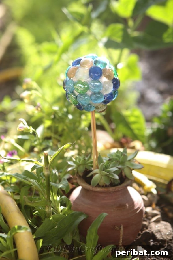 Craft Your Own Garden Spheres 12 A large DIY lawn ball nestled beside a planter, enhancing the garden's aesthetic.