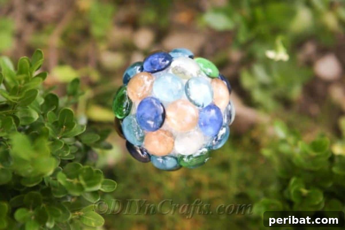 Craft Your Own Garden Spheres 3 A close-up view of a beautifully crafted DIY ball lawn ornament, showcasing the reflective glass nuggets.