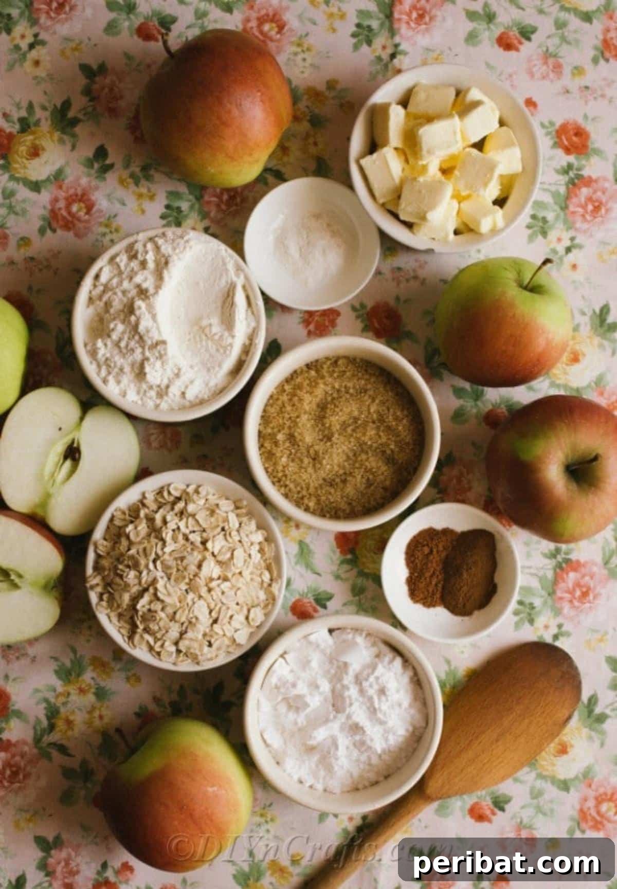 Effortless Homestyle Apple Crumble 6 Ingredients for apple crumble recipe laid out in small white bowls on a floral tablecloth, ready for preparation.