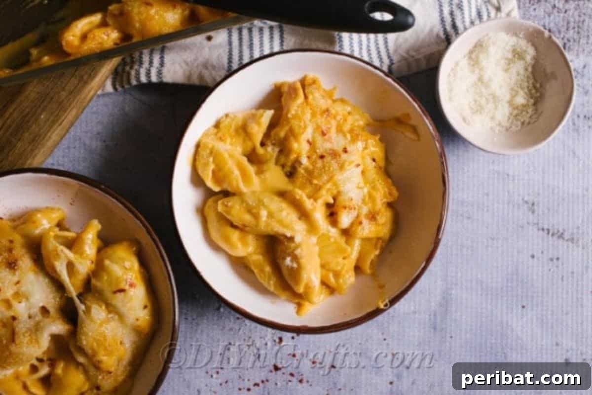 Decadent Homemade Mac and Cheese Bake 5 A generous serving of unbaked, creamy homemade mac and cheese in a large white bowl, highlighting its rich texture.