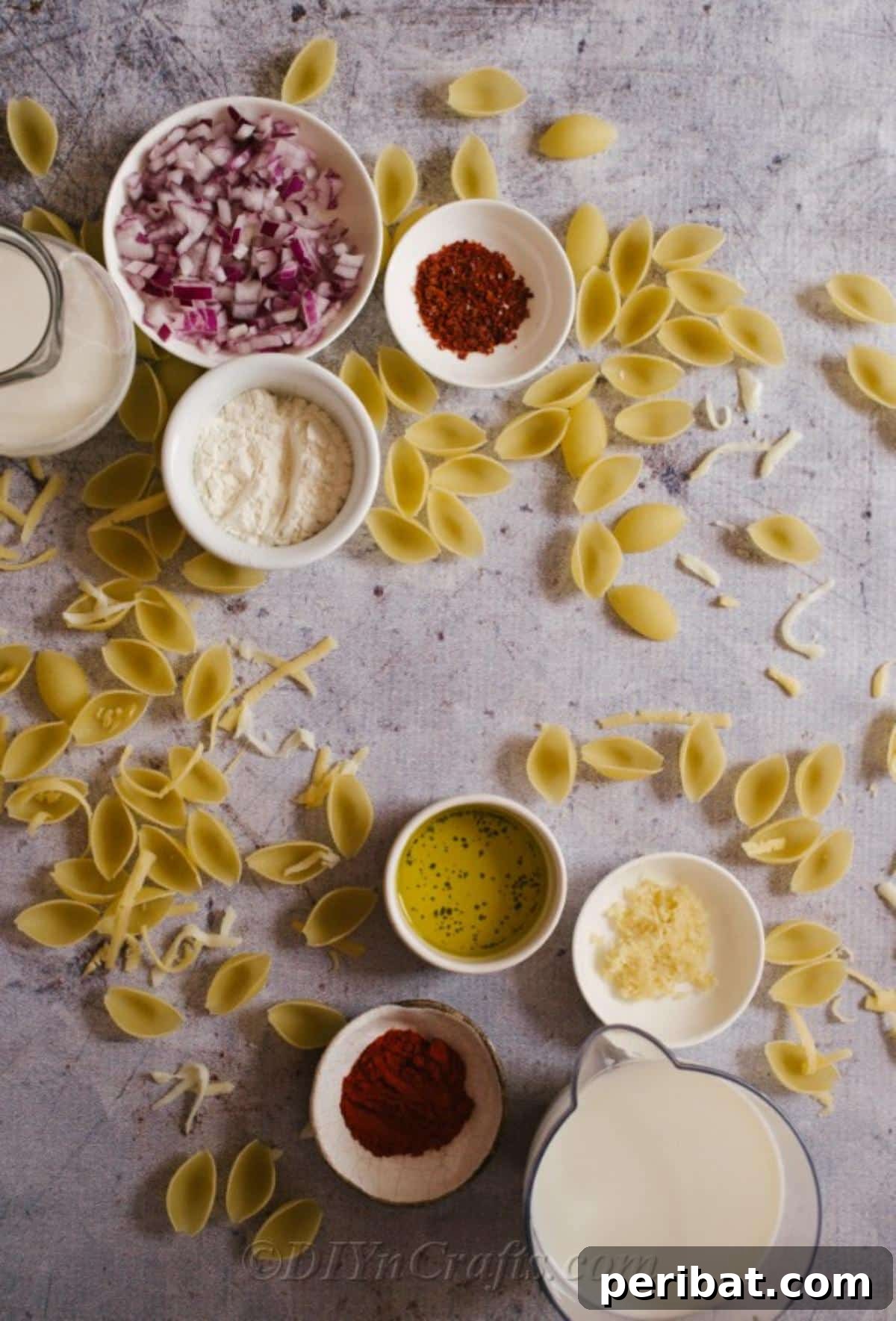 Decadent Homemade Mac and Cheese Bake 7 A vibrant flat lay image showcasing all the fresh ingredients required for the baked mac and cheese recipe, including pasta, cheeses, milk, and spices.