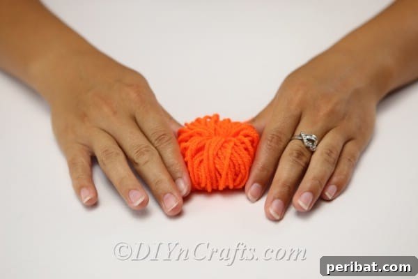 Handmade Autumn Yarn Pumpkin Garland Tutorial 16 Fluffing yarn out to make the diy fall decor yarn pumpkin look like a pumpkin