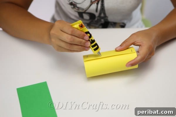 Attaching the ends of paper for core of scarecrow craft