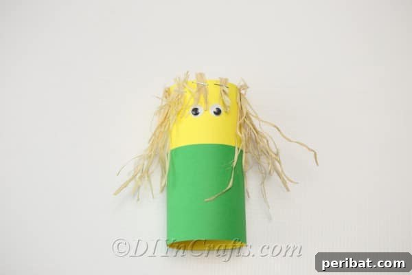 Adding googly eyes to the front of your scarecrow craft