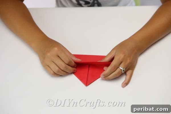Folding paper to create a hat for scarecrow craft